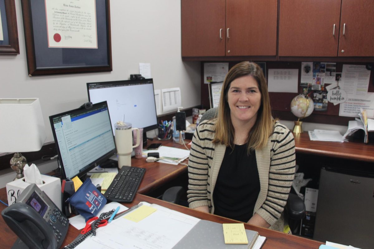 Assistant principal Mrs.Totten posing in her workplace.