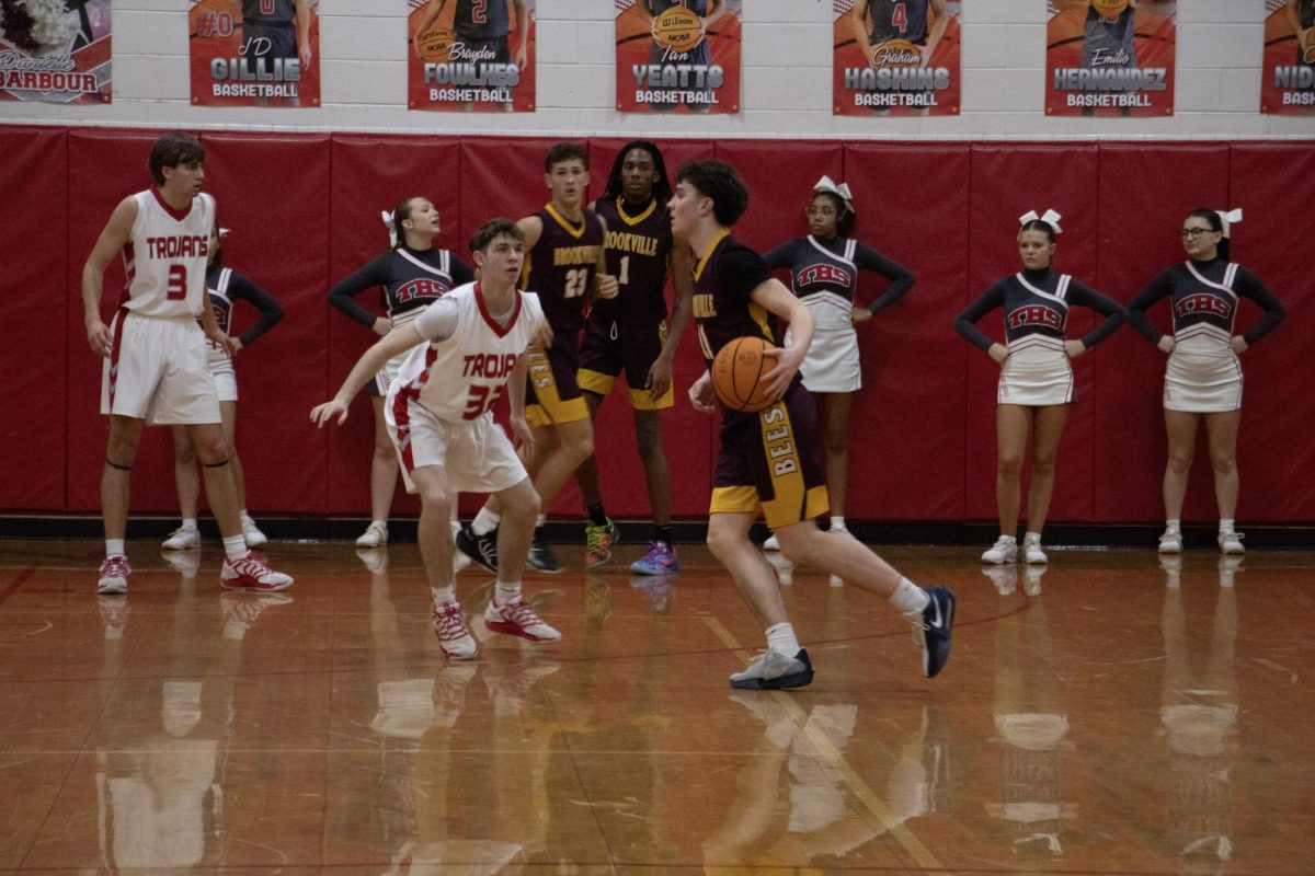 Freshman Avery Nidiffer on defense against the bees