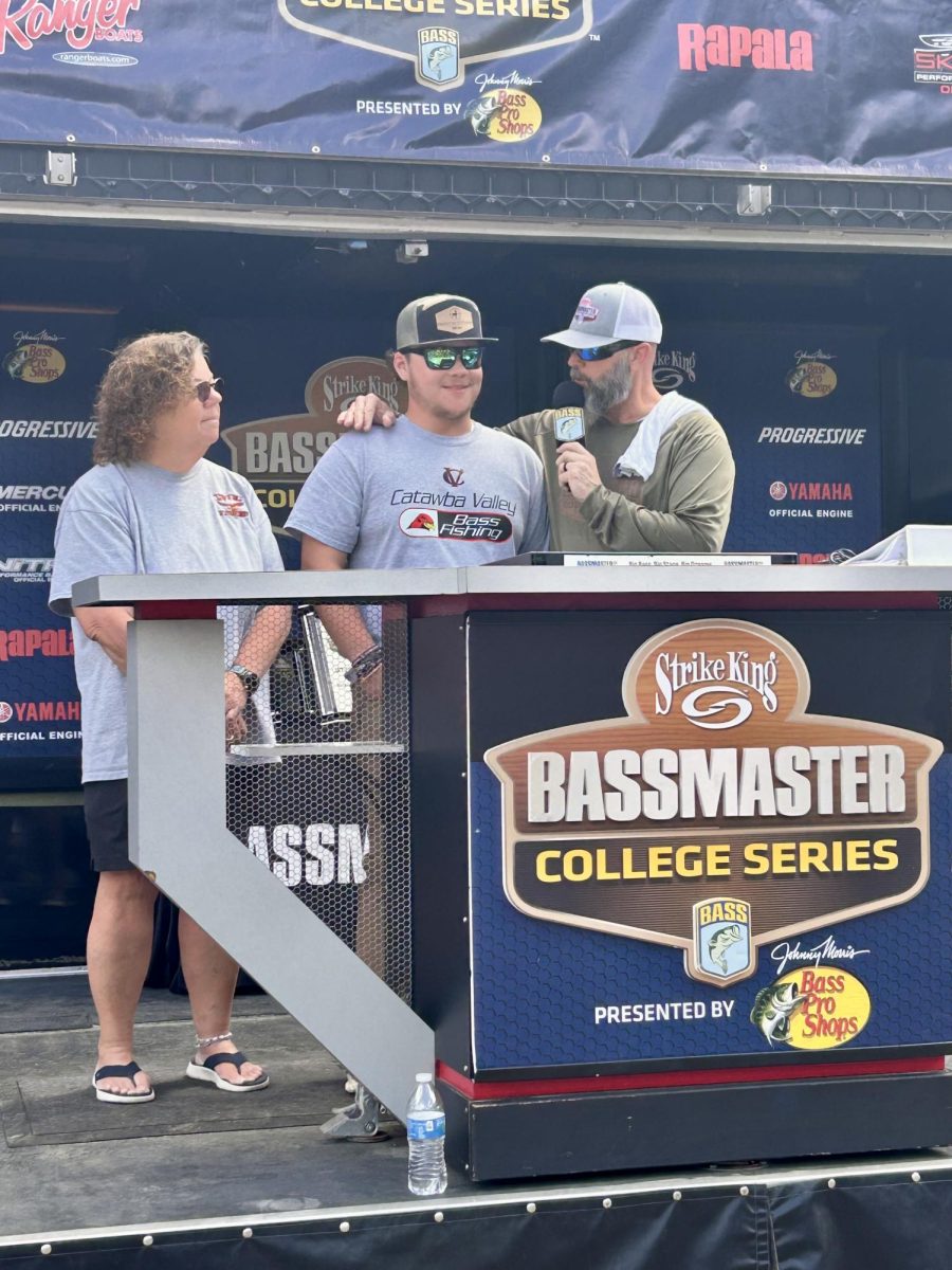 Senior Tanner Sims in the process of signing to college for fishing.