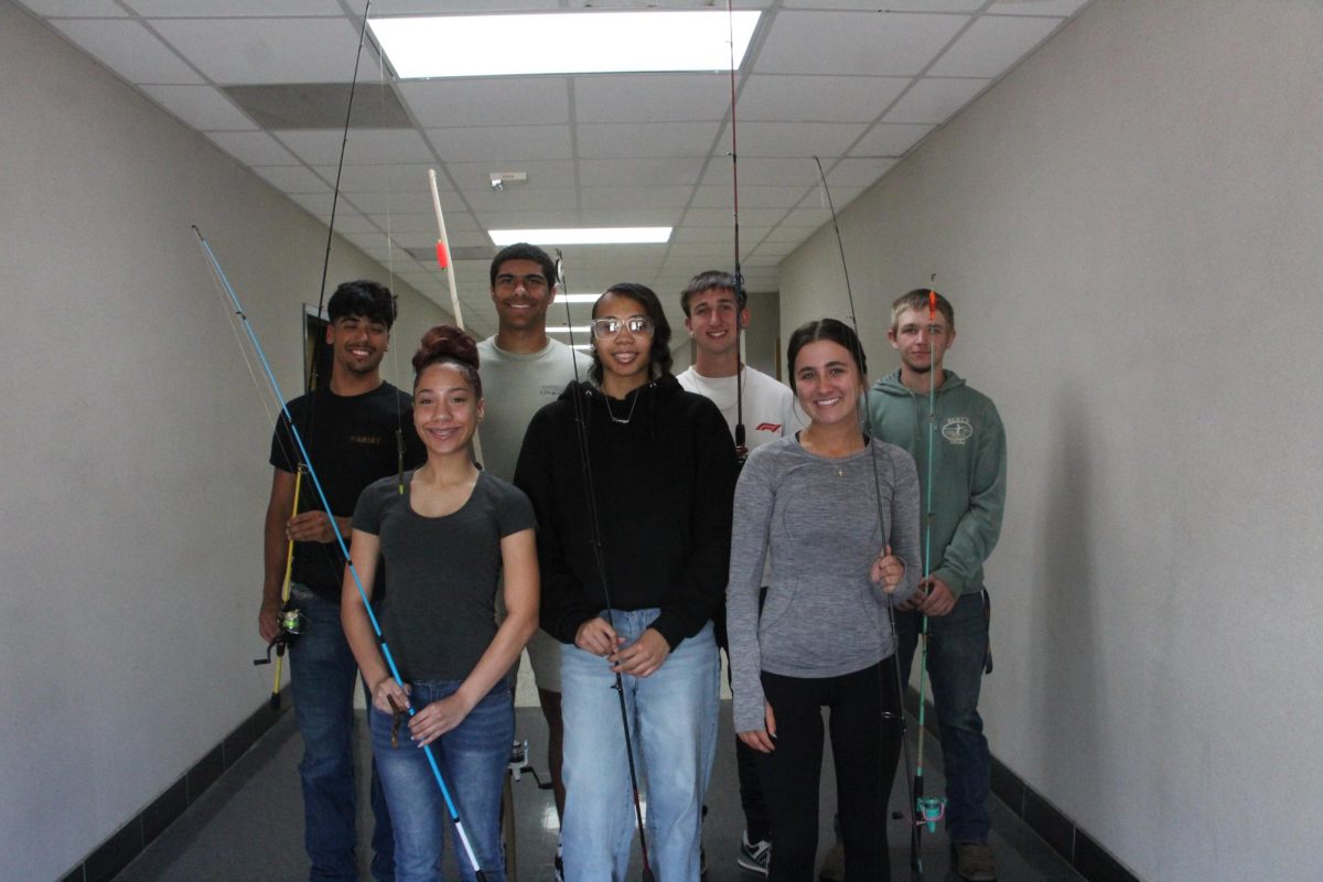 Student in Fishery and Wildlife holding their fishing rods. 