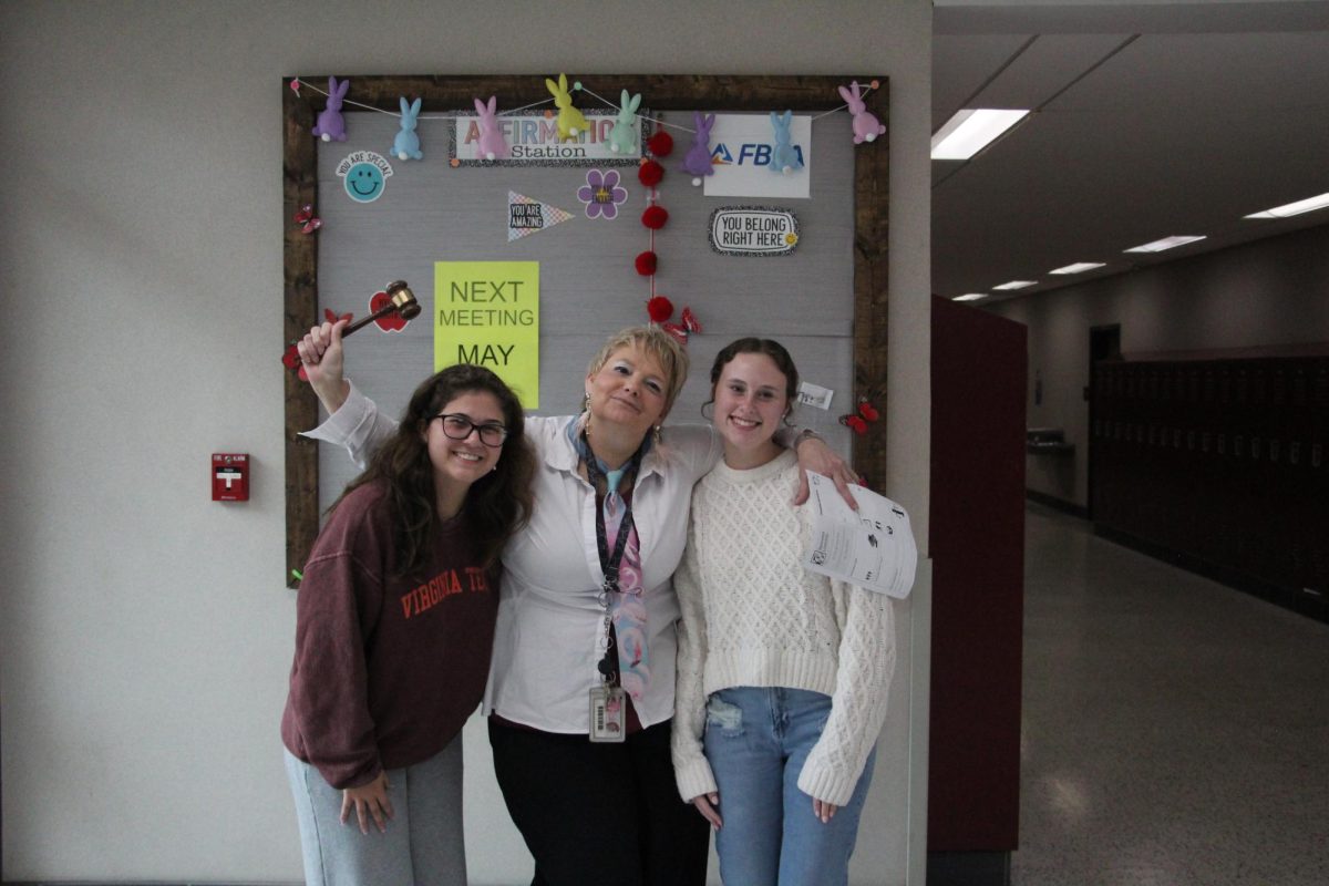 Senior Carolina Wheeler and Madeline Jones standing with Mrs. Carter.